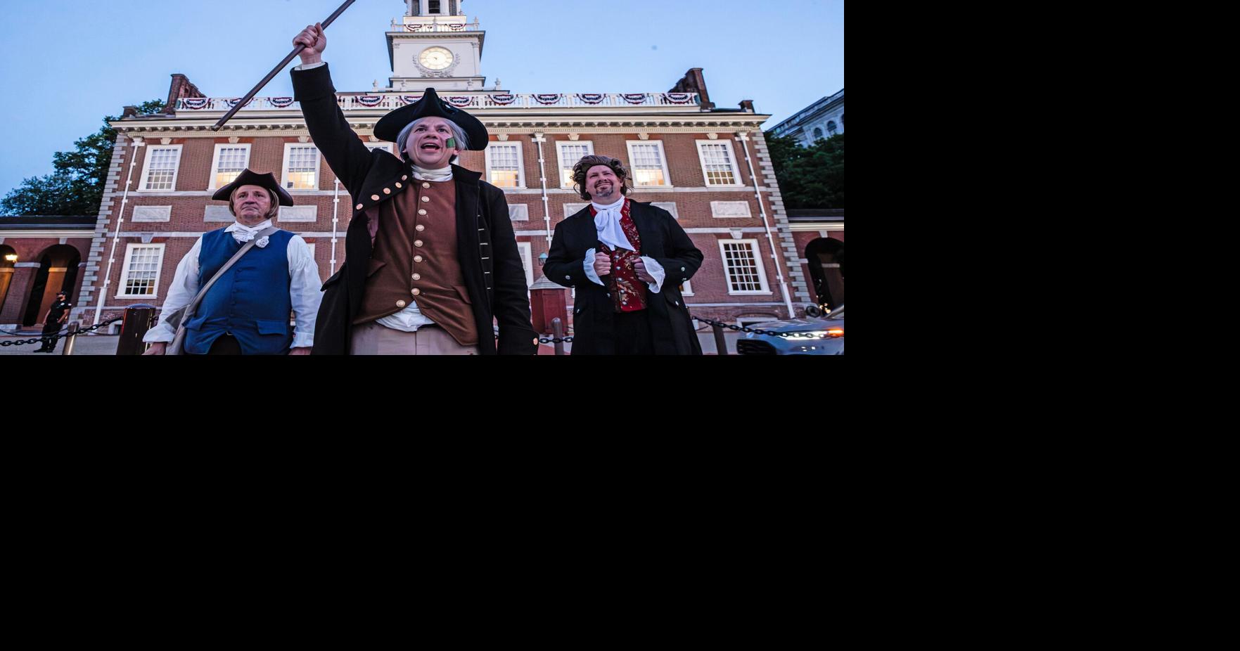 “I vote yes for independence,” says Ciro Poppiti, portraying Caesar Rodney, flanked by Hugo Immediato Jr., left, portraying Jacob Broom, and Primus Poppiti, portraying Thomas Rodney, in front of Independence Hall during a commemoration of the 250th ann