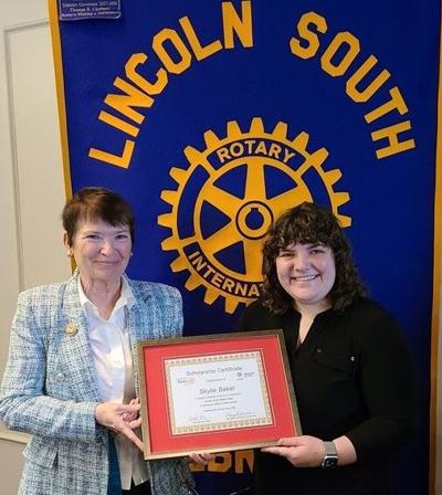 Mary Gilbride presents scholarship to Skylie Baker