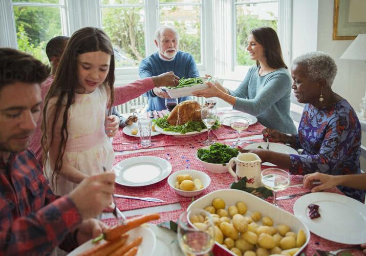 Multi-generation family eating at holiday dinner table