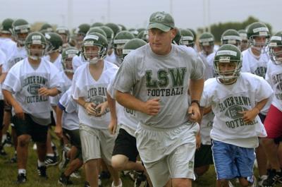southwest lincoln coach football school norfolk suspended mark game king journalstar leads onto practice 2002 field head team his