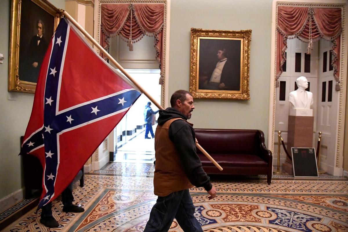 Man carrying Confederate flag inside US Capitol during riot arrested in Delaware