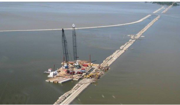 Barge building a bridge at Big Lake