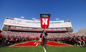 UNL grads cross the stage to receive diplomas, some for the first time