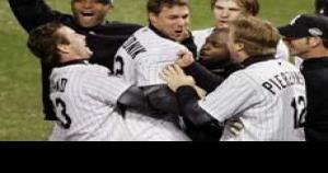 Chicago White Sox Aaron Rowand, right, greets A. J. Pierzynski at the  dugout after Pierzynski scored on Scott Podsednik's triple during the ninth  inning of game 1 of the World Series against