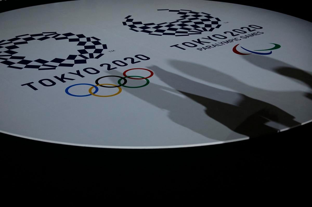 The emblems of the Tokyo 2020 Olympic and Paralympic Games are displayed during an event to unveil the medals, podium and music to be used for the medal ceremonies at the Tokyo 2020 Olympics Games at Ariake Arena in Tokyo on June 3, 2021.
