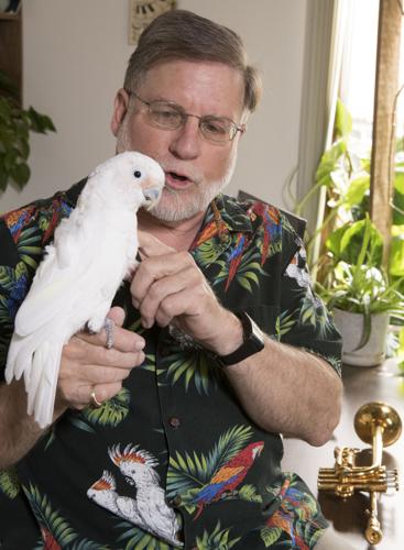 Dean Haist with Sophie, his cockatoo