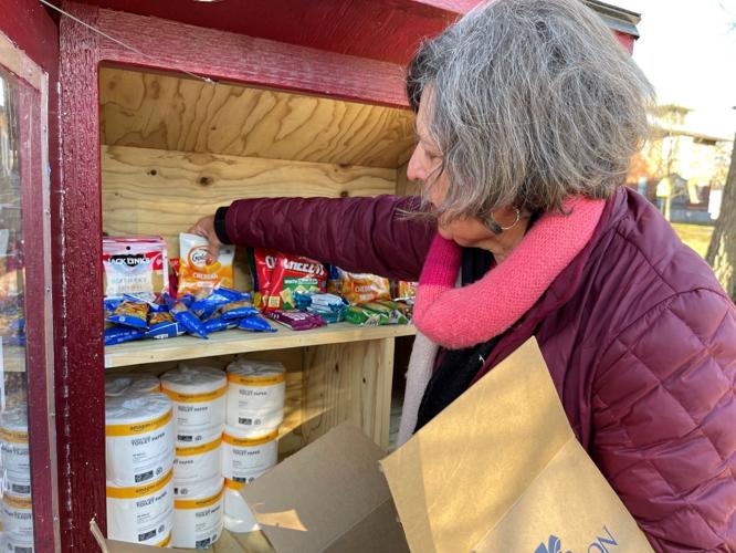 DeEtta Vrana stocks the Little Free Pantry