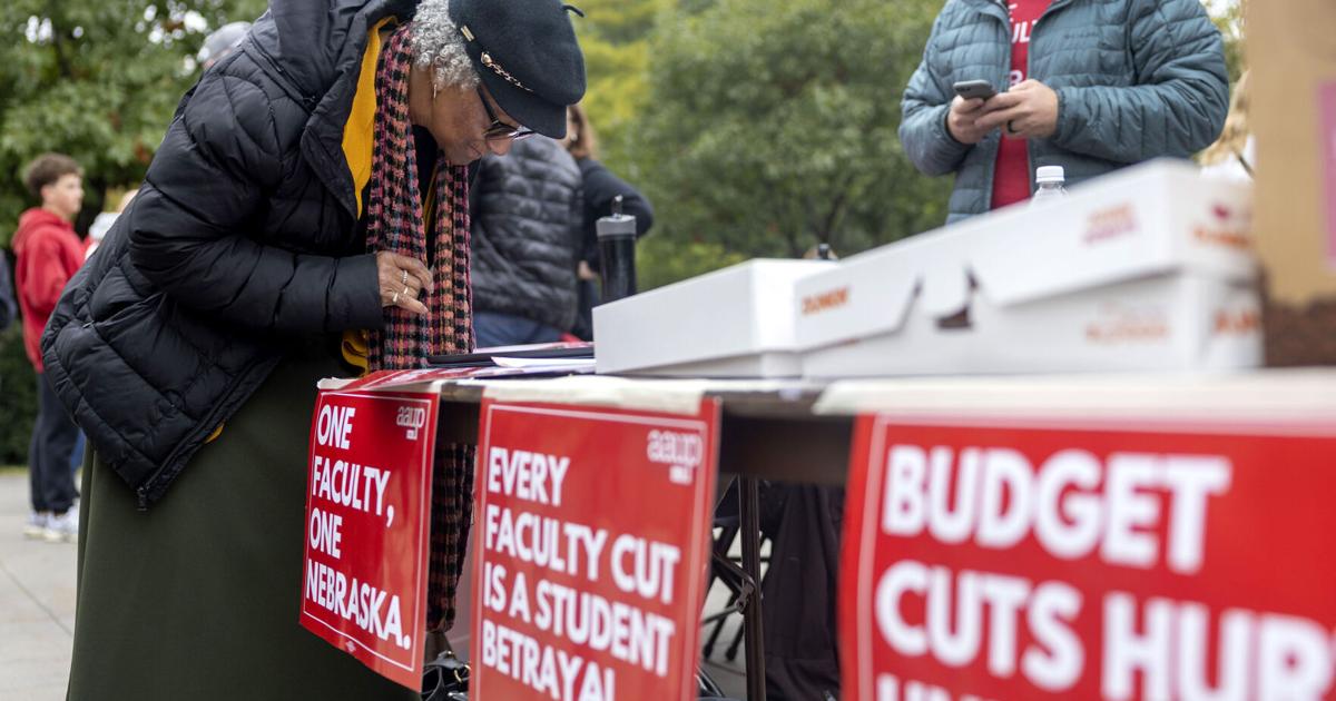 Advocates protest budget cuts as football fans make way to Memorial Stadium