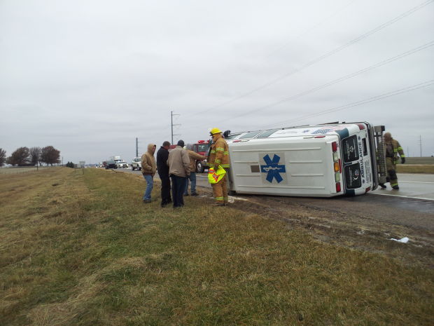 Private ambulance rolls, patient inside, on Nebraska 2