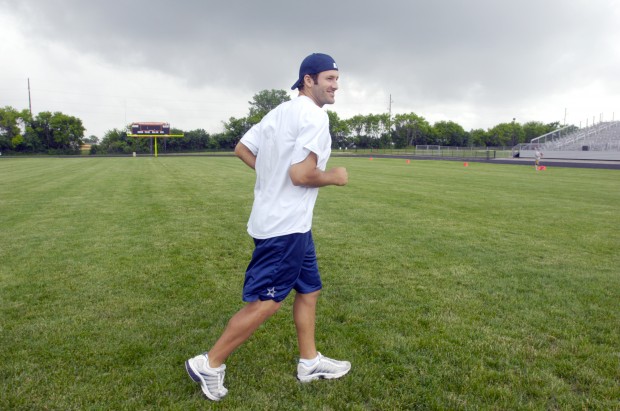 Candice Romo, wife of Dallas Cowboys quarterback Tony Romo, hands out  headbands she had bought for the girls registered during Romo' annual  football fundamentals camp at Burlington High School, Wednesday June 22