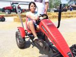 Mariana Bautista rides mini-tractor at Racine County Fair