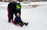 Father and son on the sledding hill