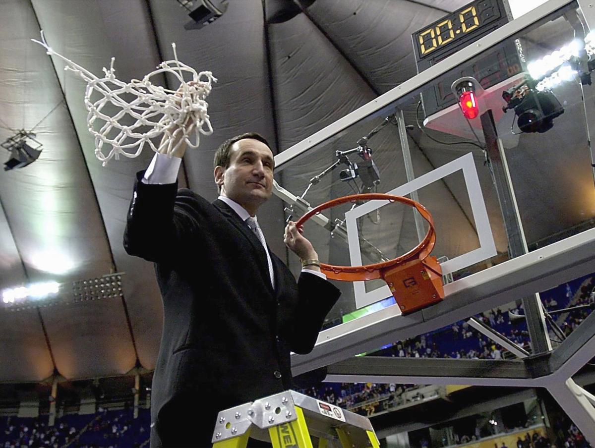 Duke head coach Mike Krzyzewski cuts down the net after the Blue Devils' 82-72 victory against Arizona to win the NCAA National Championship at the Metrodome in Minneapolis on April 2, 2001.