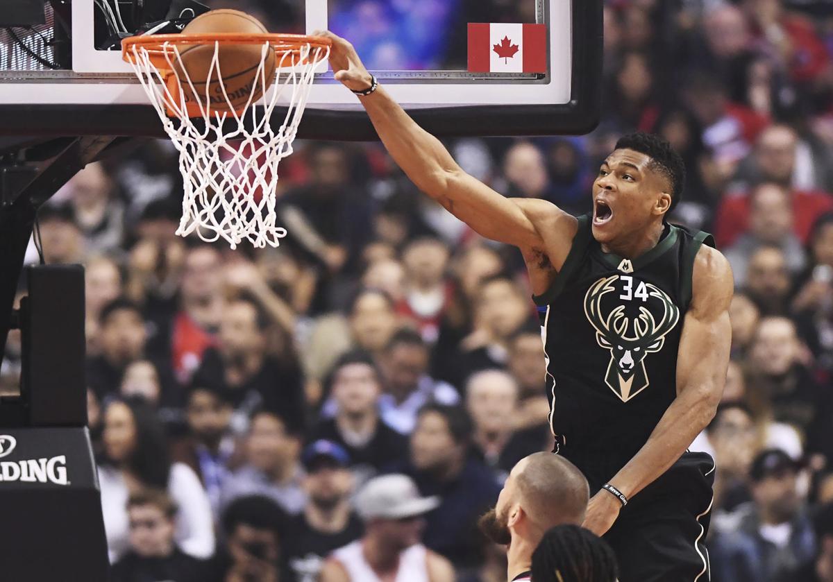 Giannis Antetokounmpo dunks in playoffs, AP photo