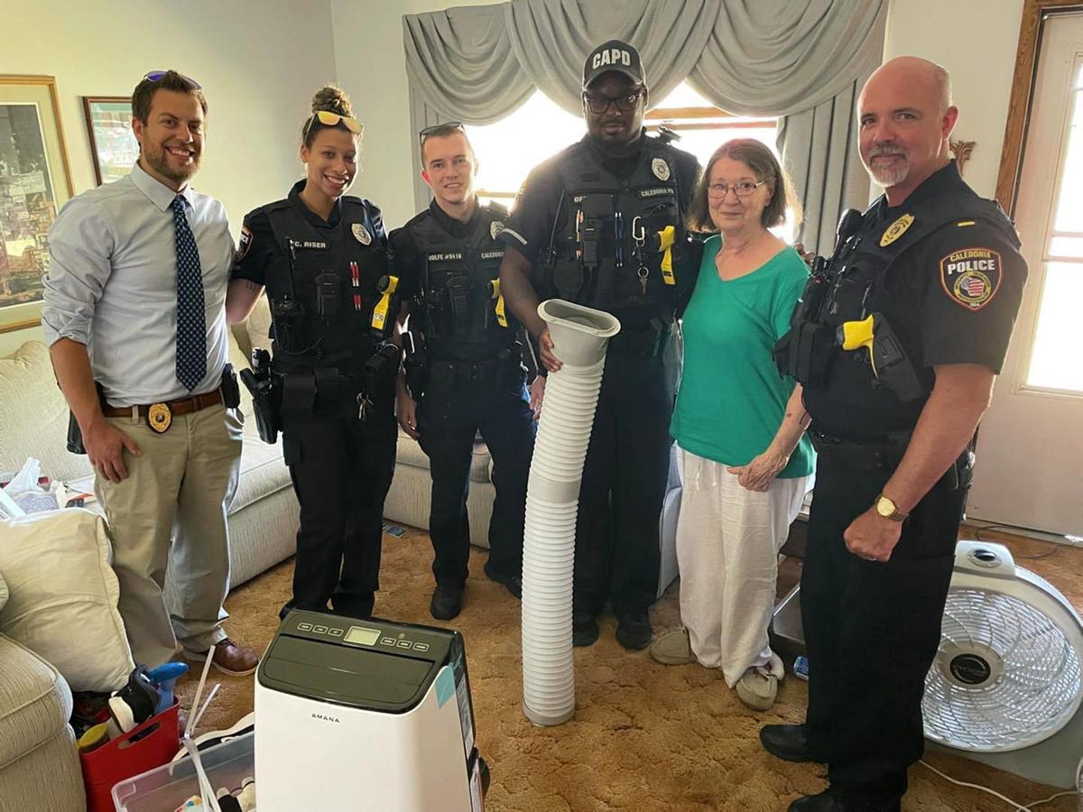 Caledonia Police Department poses with woman