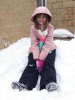 Olivia Buford, 8, of Burlington plays in the snow