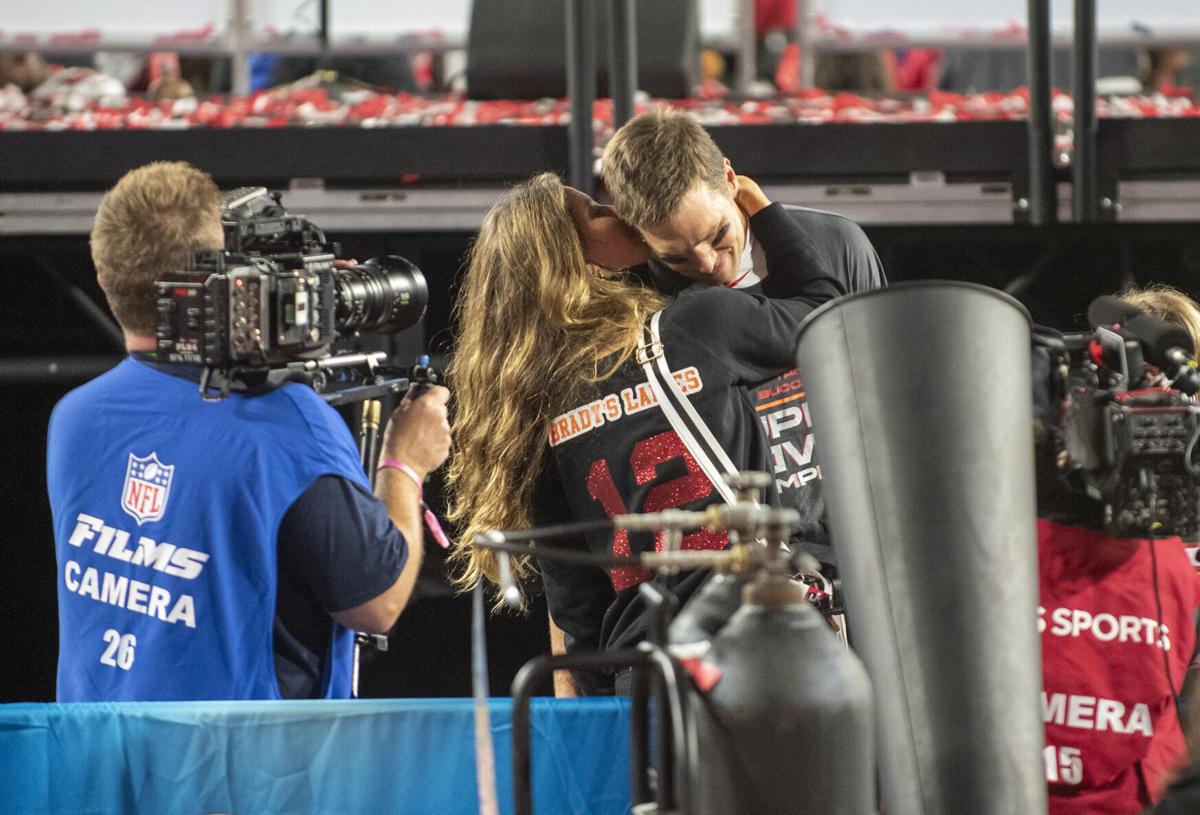 Tampa Bay Buccaneers quarterback Tom Brady receives a kiss from his wife Gisele Bundchen as the Tampa Bay Buccaneers celebrate their 31-9 win over the Kansas City Chiefs with his children in Super Bowl LV Sunday, February 7, 2021 in Tampa, Florida.