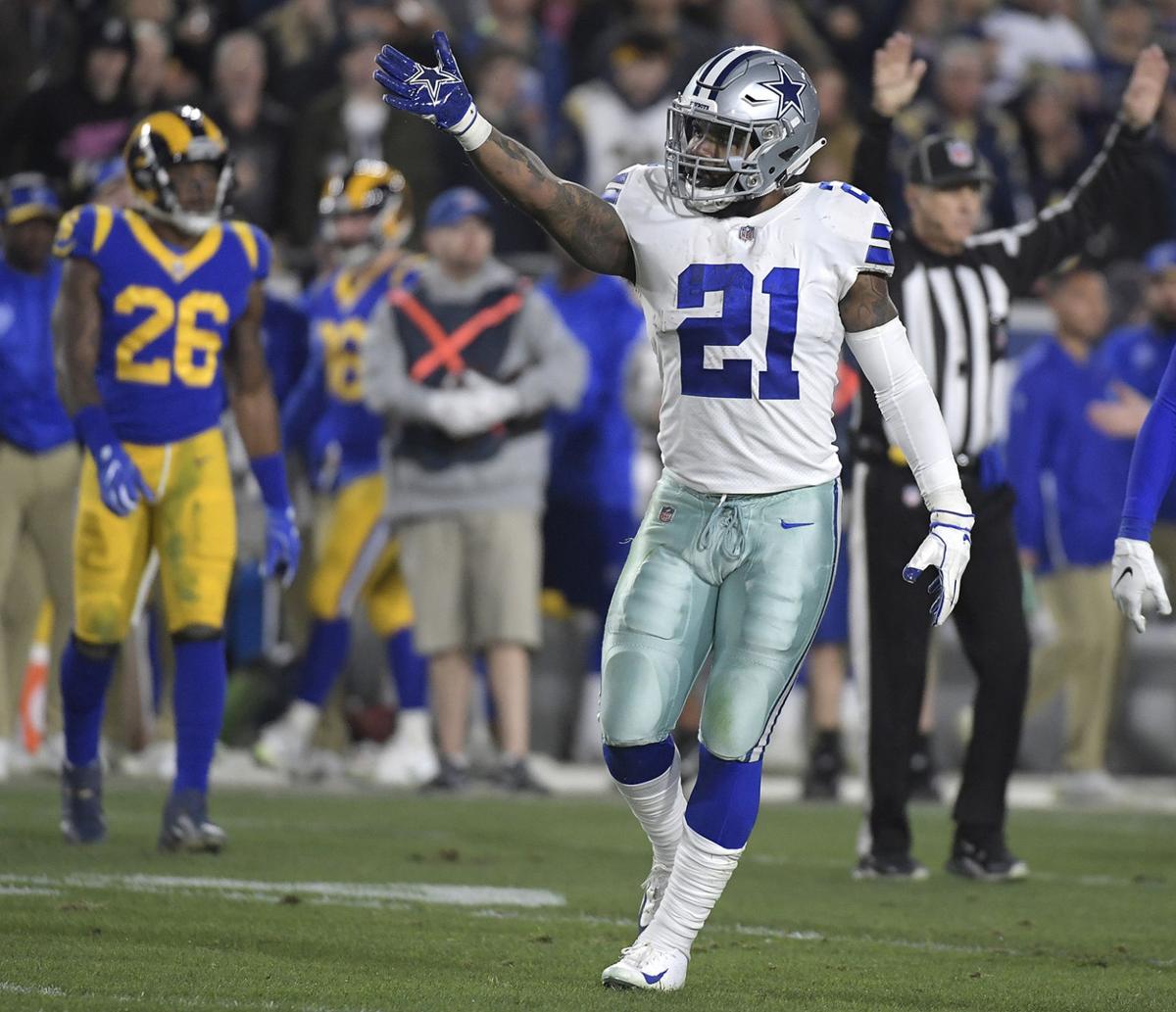 On fourth-and-1, Dallas Cowboys head coach Jason Garrett goes for it and running back Ezekiel Elliott (21) picks it up during the first quarter against the Los Angeles Rams in the NFL Divisional Round at the Los Angeles Memorial Coliseum on Saturday, Jan. 12, 2019.