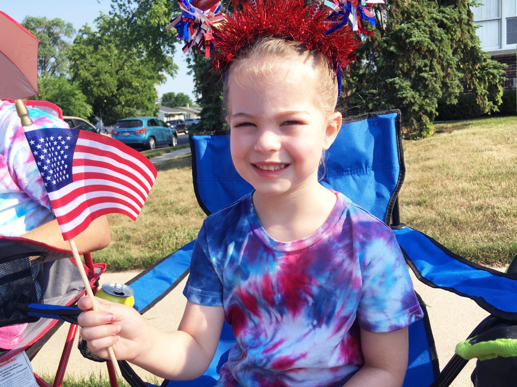 Payton Tomczak, 5, waves her flag during Fourth of July parade in Union Grove