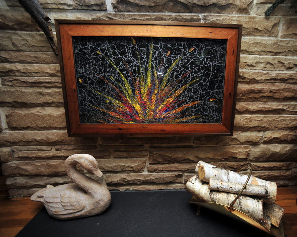 Local artist’s shatteredglass fireplace covers debut at trade show