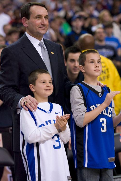 In March 2009, Duke head coach Mike Krzwzewski and his grandsons Michael Savarino, left, then age 8, and Joey Savarino, then 9, watch the Blue Devils cut down the nets after capturing the ACC Tournament at the Georgia Dome in Atlanta.