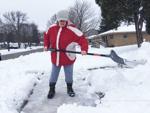 Kayla Olalde shovels snow in Burlington