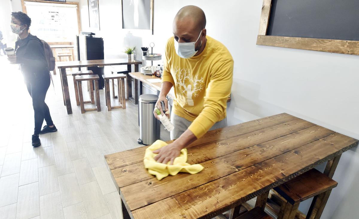 Wiping down tables at The Main Project