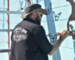 Dean Tawwater painting the new mural at the intersection of Memorial & Ninth Street.