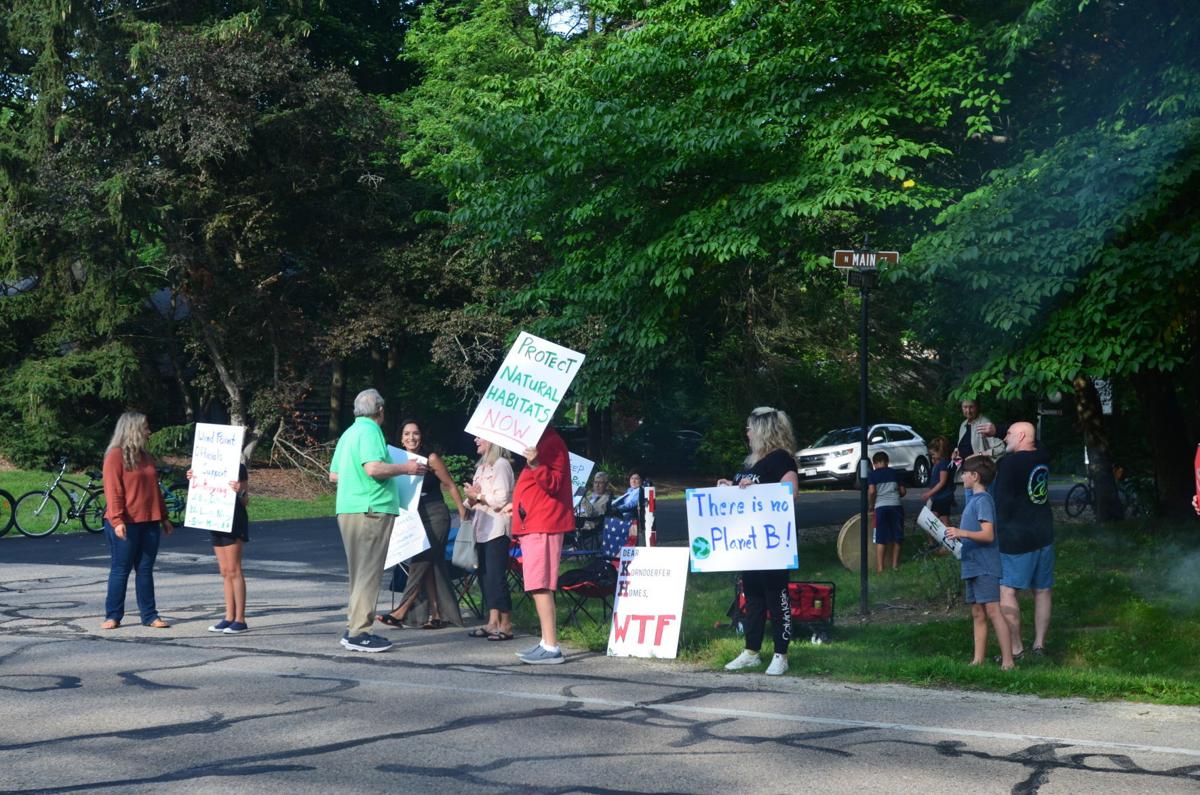 Protesters hold signs