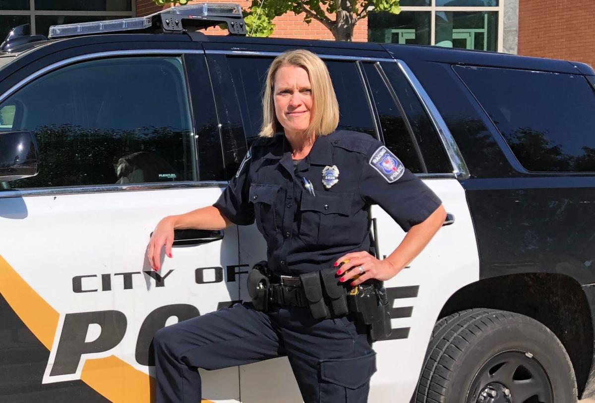 Jennifer Diener poses next to her squad car