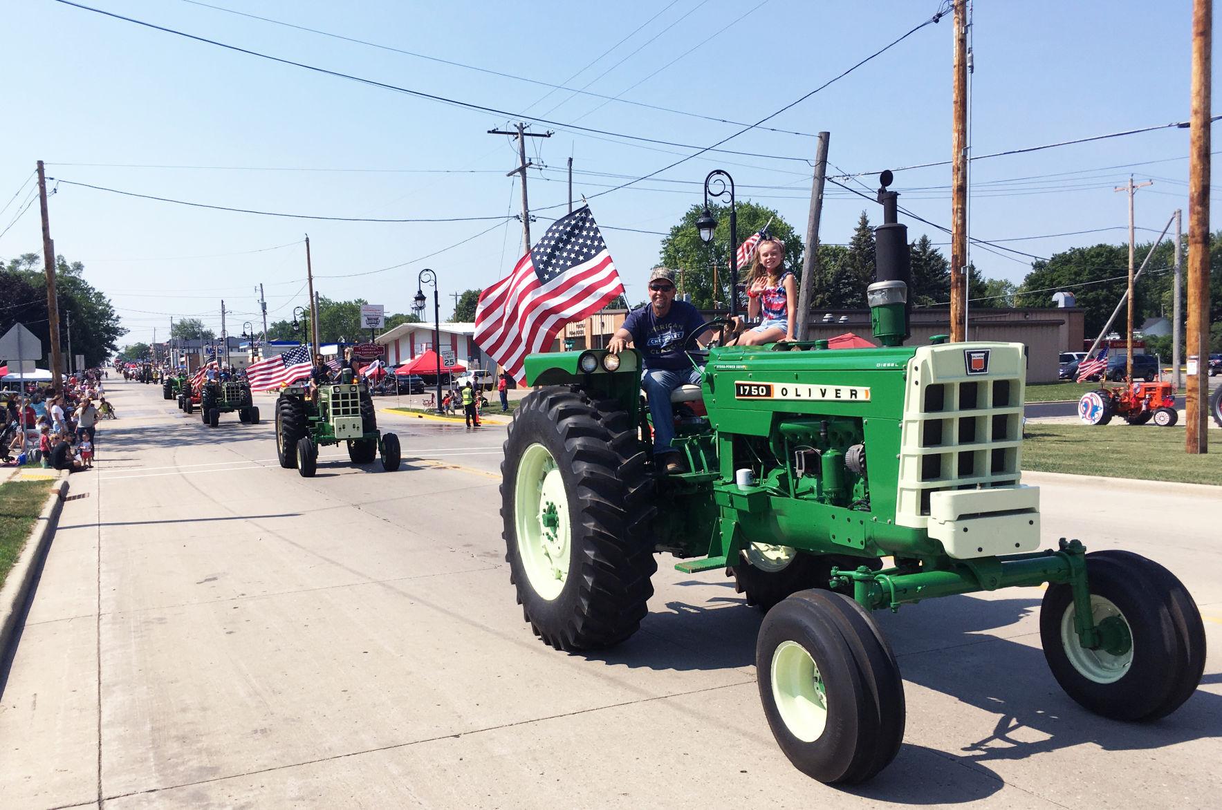 Greg Hegemann and granddaughter on tractor in Fourth of July parade
