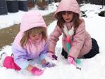 Sisters Olivia and Sophie Buford play in the snow in Burlington