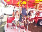 Michelle Muzia and grand-daughter Cecilia Venegas on carousel at Racine County Fair