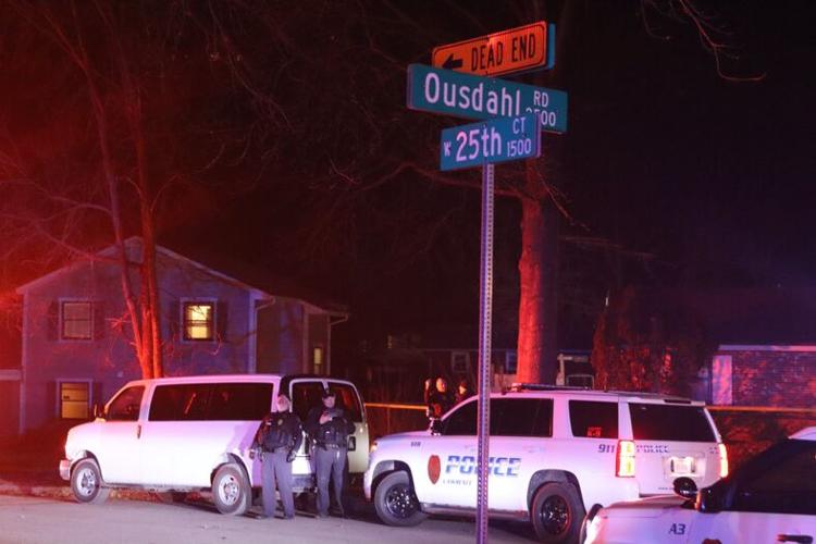 The corner of 25th and Ousdahl, illuminated by police vehicle lights following the standoff