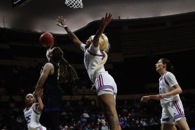 Kansas basketball players watch a ball in the air