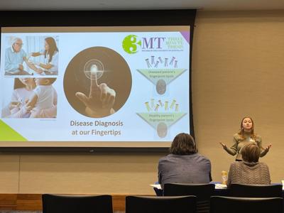 Student gives presentation at Three Minute Thesis competition