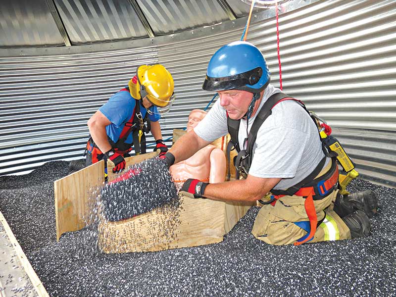 Grain rescue tube training teaches firefighters how to free trapped