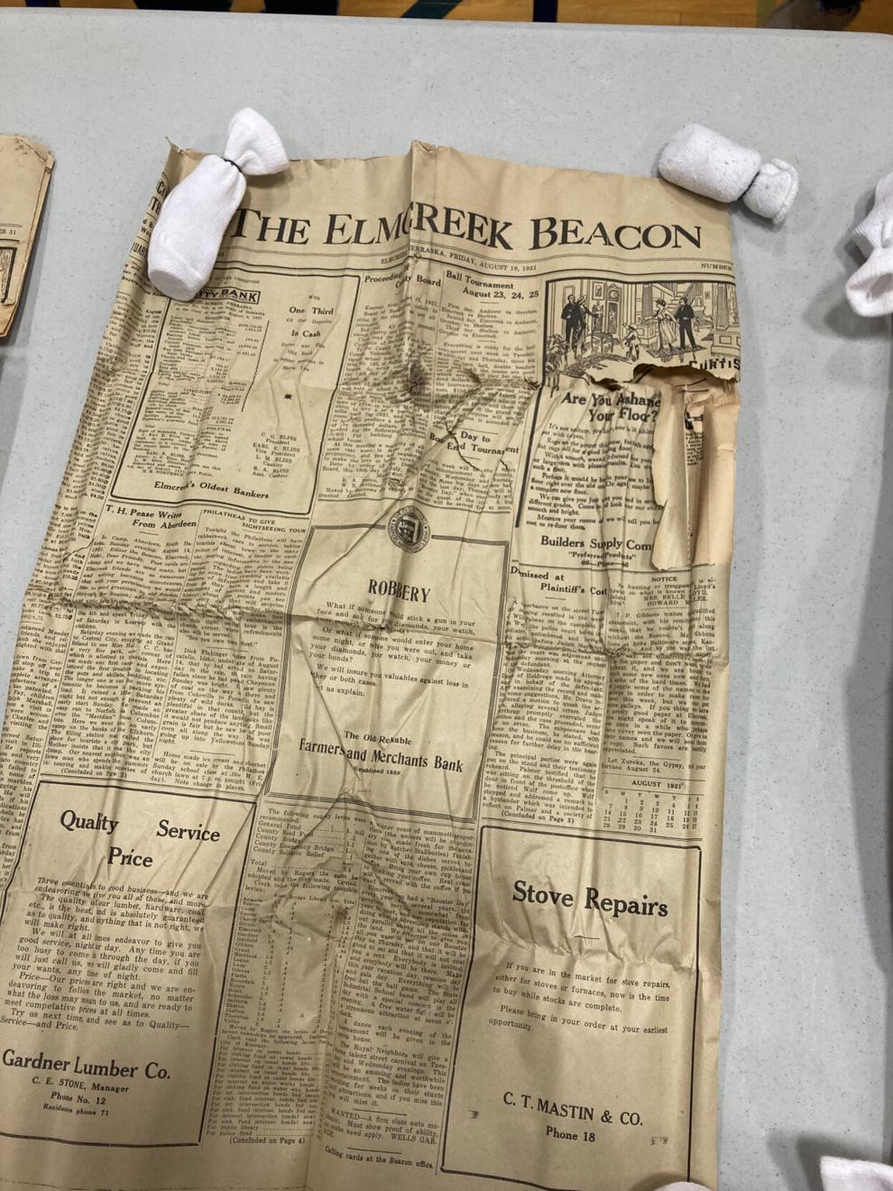 A penny. Old newspapers. Treasures found in Elm Creek