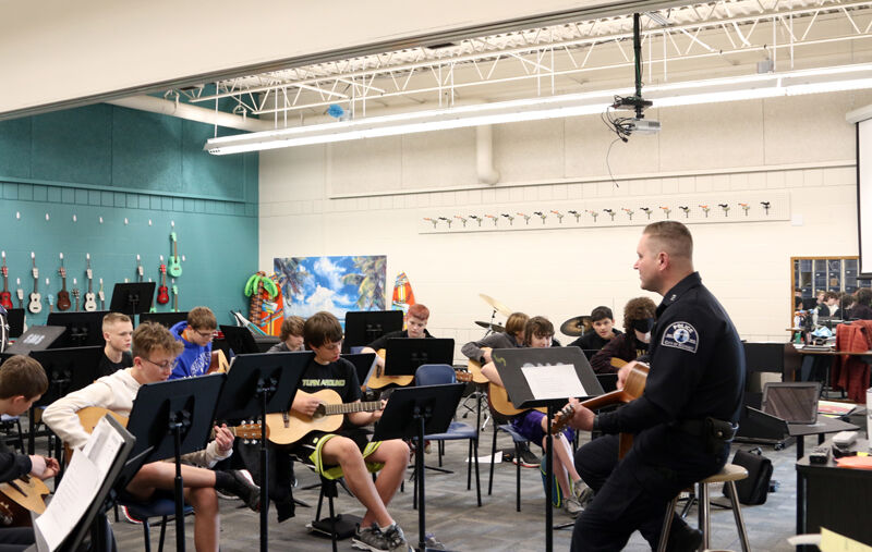 Kearney Public Schools Resource Officer Cody Weldon helping students