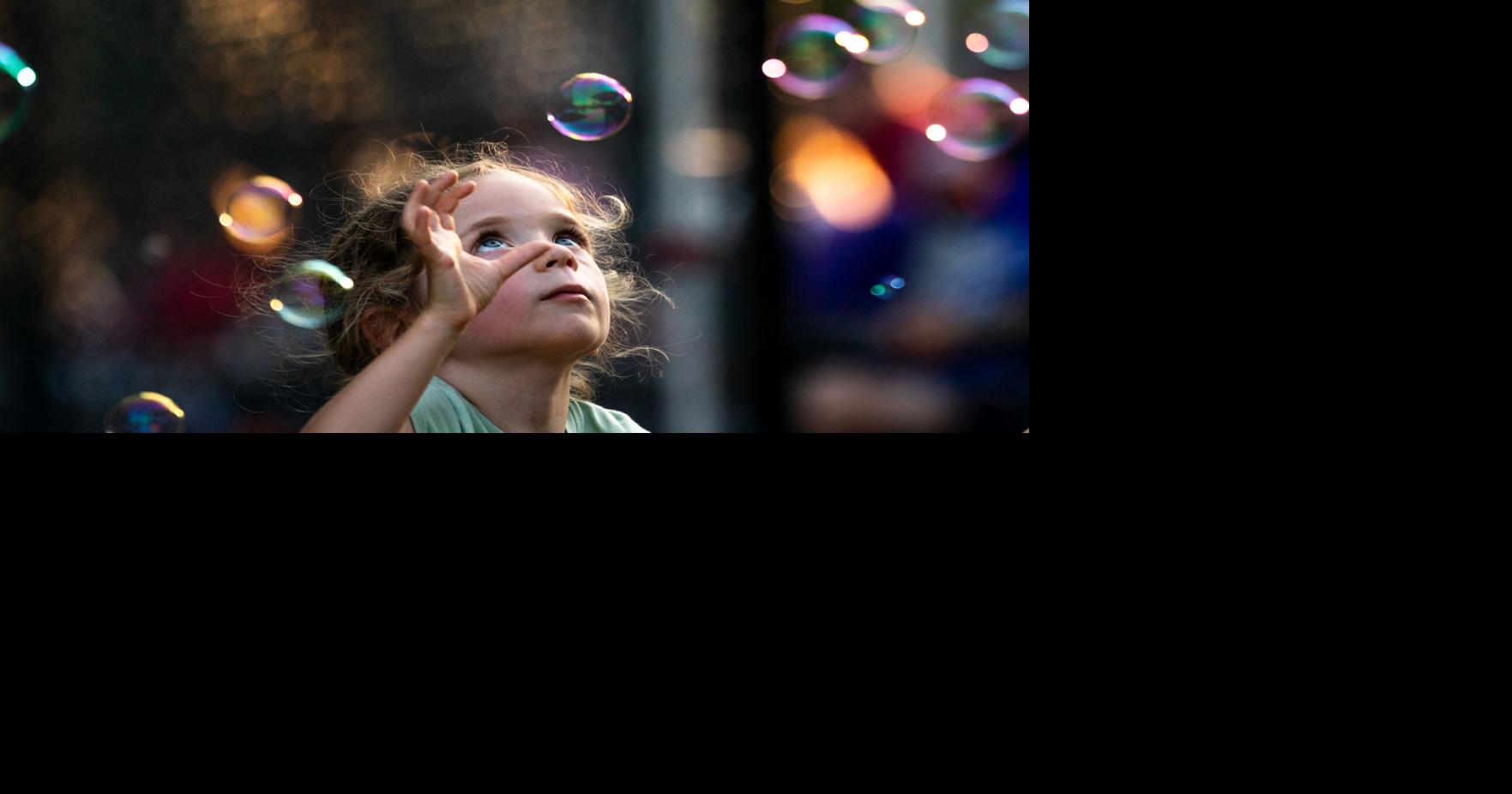 Claire McCants, 4, of North Walpole plays with bubbles