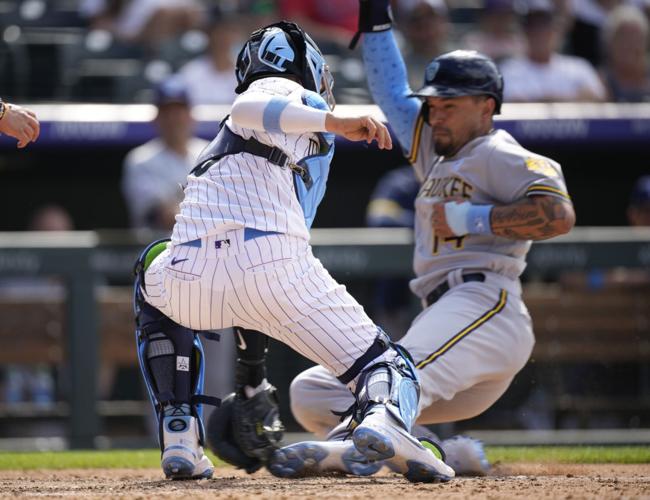 Milwaukee Brewers' Daniel Vogelbach reacts after avoiding a high, inside  pitch from Colorado Rockies relief pitcher Daniel Bard in the ninth inning  of a baseball game Sunday, June 20, 2021, in Denver.