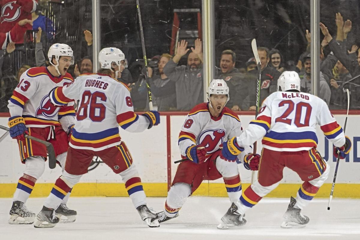 Devils’ rally, stop Rangers in OT