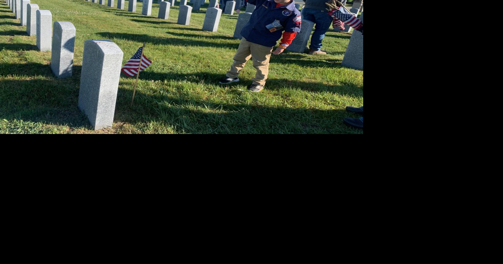 Volunteers place flags at Southern Wisconsin Veterans Memorial Cemetery ...