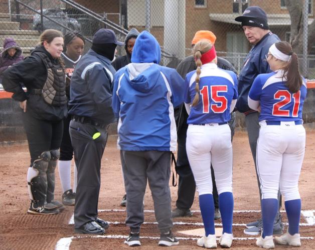 Christian County Lady Colonels and Hopkinsville Lady Tigers players meet at home plate Monday night