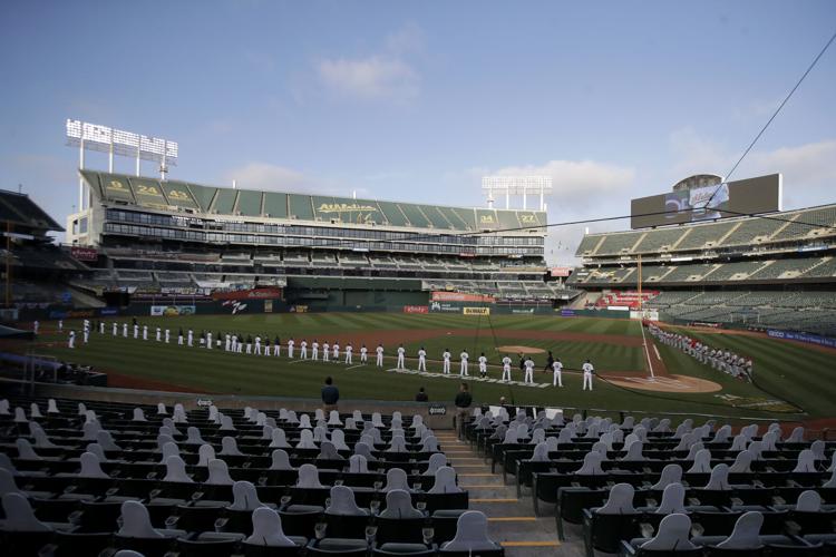 Empty stands, masked players as baseball returns