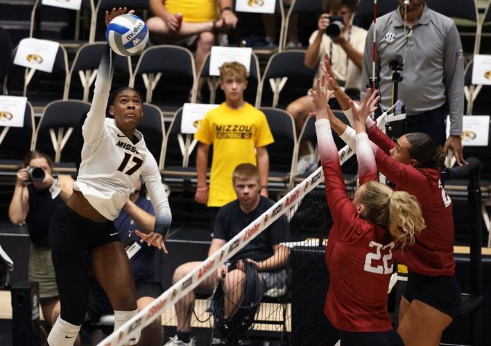 Caylen Alexander (17) spikes the ball