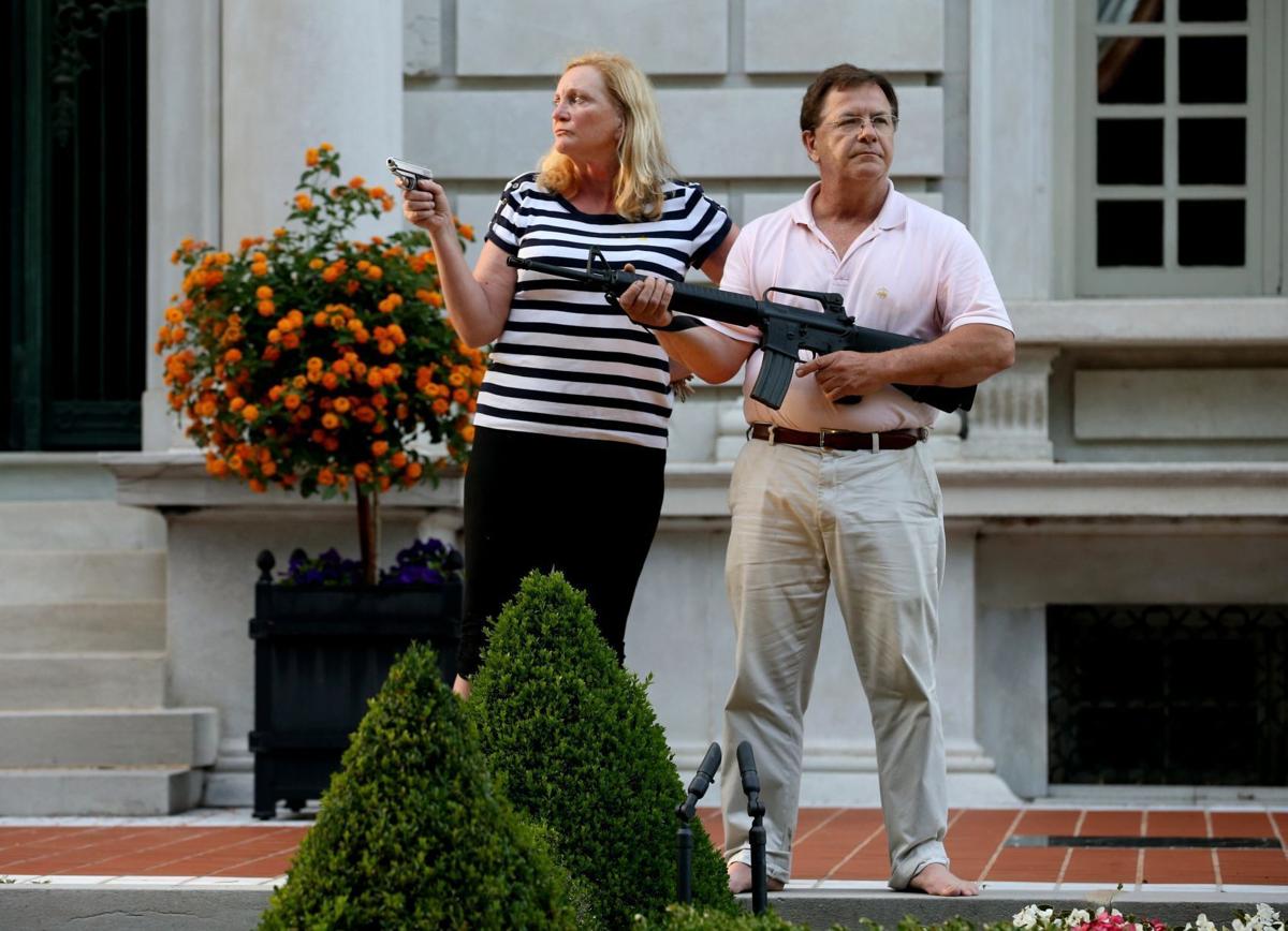 CWE couple display guns during protest