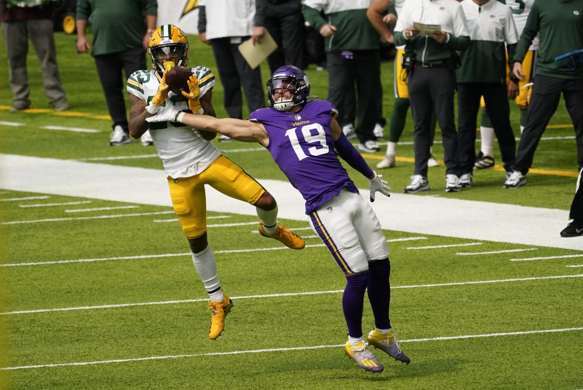 Jaire Alexander intercepts a pass intended for Minnesota Vikings wide receiver Adam Theilen