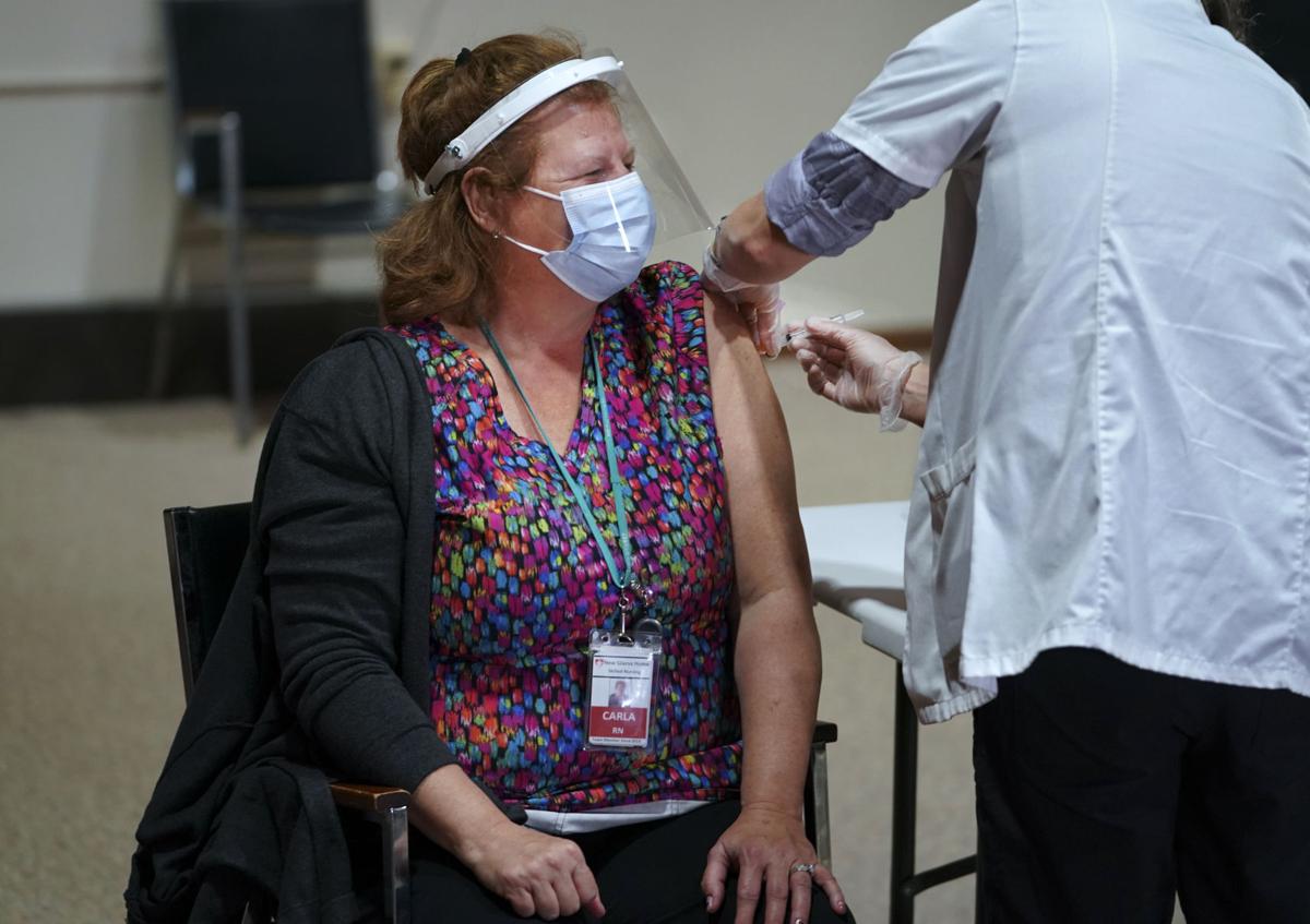 Nursing home nurse gets COVID-19 vaccine