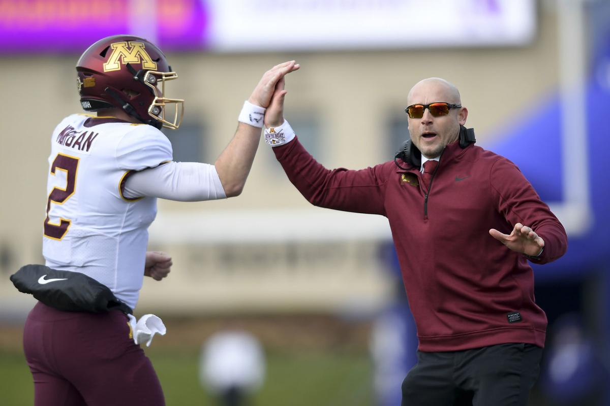 Minnesota Gophers quarterback Tanner Morgan (2) high-fives head coach P.J. Fleck after Morgan's fourth quarter touchdown pass to wide receiver Tyler Johnson (6) on Saturday, Nov. 23, 2019 at Ryan Field in Evanston, Ill.